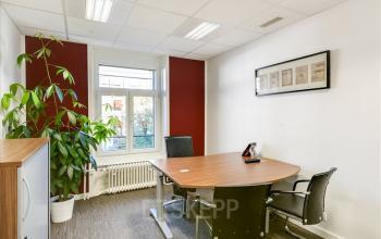 Office space rental available at Bahnhofstrasse 100, Zürich Center, with a furnished interior including a desk, chairs, and green plants by the window.